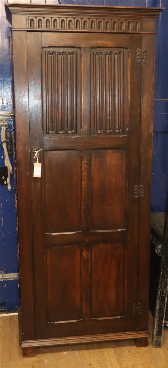 A reproduction oak linenfold hall cupboard W.74cm